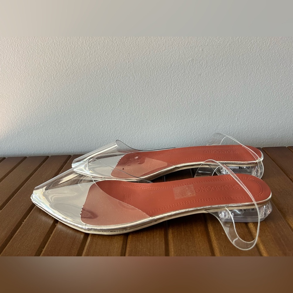 Clear peep toe sling back flats.